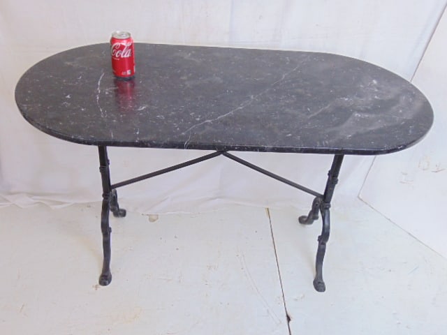 Oval marble top Italian table on iron base, black marble, base painted black, table is 48.5" by (1 of 5)