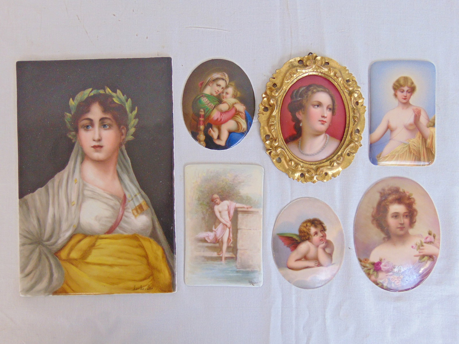 7 small porcelain painted plaques, portrait of Sappho, woman in laurel wreath, after Nathaniel: 7 small porcelain painted plaques, portrait of Sappho, woman in laurel wreath, after Nathaniel Sichel, 8.5" by 5 5/8"; small German plaque, "Im Bade", 4 3/8" by 2.75"; plaque, portrait of Clotho spinn