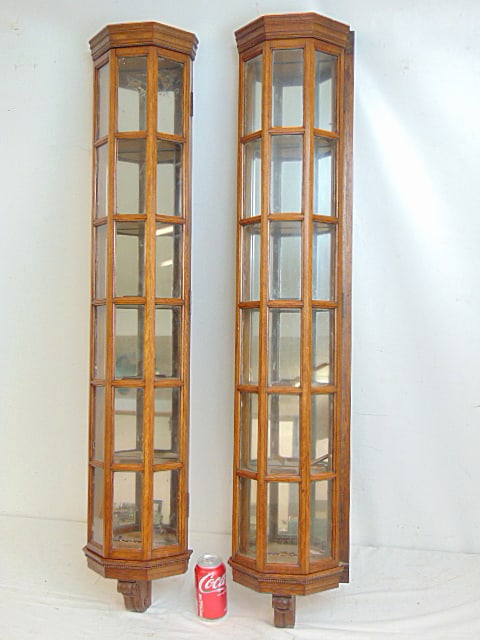 Pair oak hanging curio or collectible cabinets raised glass panel construction with mirrored backs,: Pair oak hanging curio or collectible cabinets raised glass panel construction with mirrored backs, each case has 5 shelves, excellent quality, 4 feet tall, 9" wide.