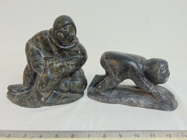 2 Inuit carved stone figures, parka clad figure with net (?) & crouching figure of a child, signed, (1 of 9)