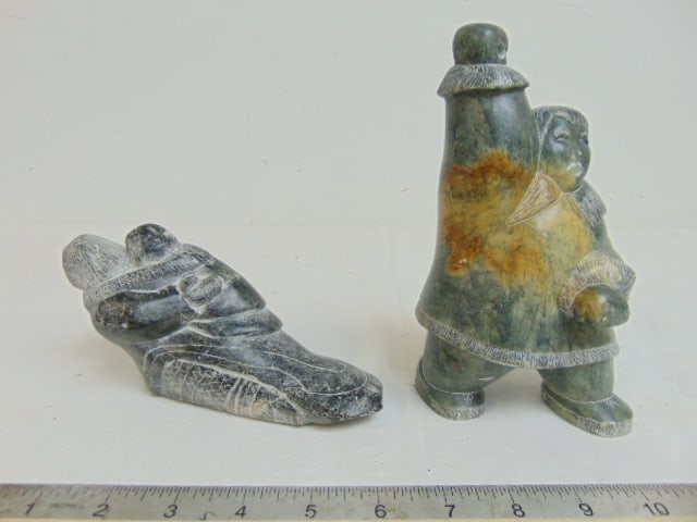 2 carved stone Inuit figural carvings, figure in parka holding a (missing) spear & mother with (1 of 8)