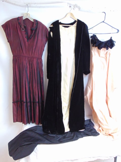 4pc Vintage clothing to include 3 party dresses and one black velvet opera cape w/ hood, this lot is (1 of 6)