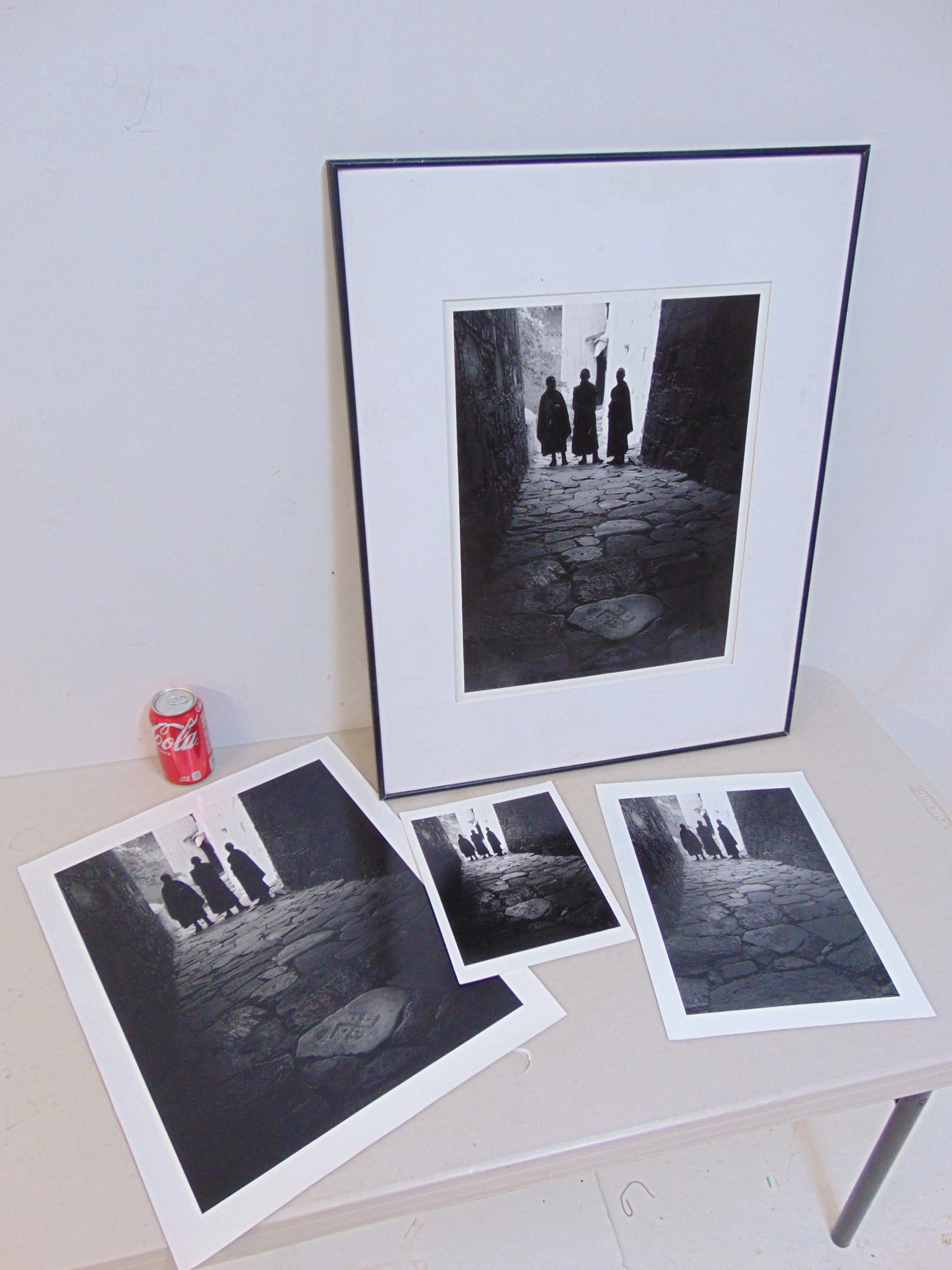 4 photographs, (Iris Prints), Chris Rainier, "3 Monks, Tibetan Symbol of Universe, Tibet": 4 photographs, (Iris Prints) Chris Rainier, "3 Monks, Tibetan Symbol of Universe, Tibet", one inscribed on reverse, one framed, large photos are 20" by 16", medium photo is 14" by 11", small photograp
