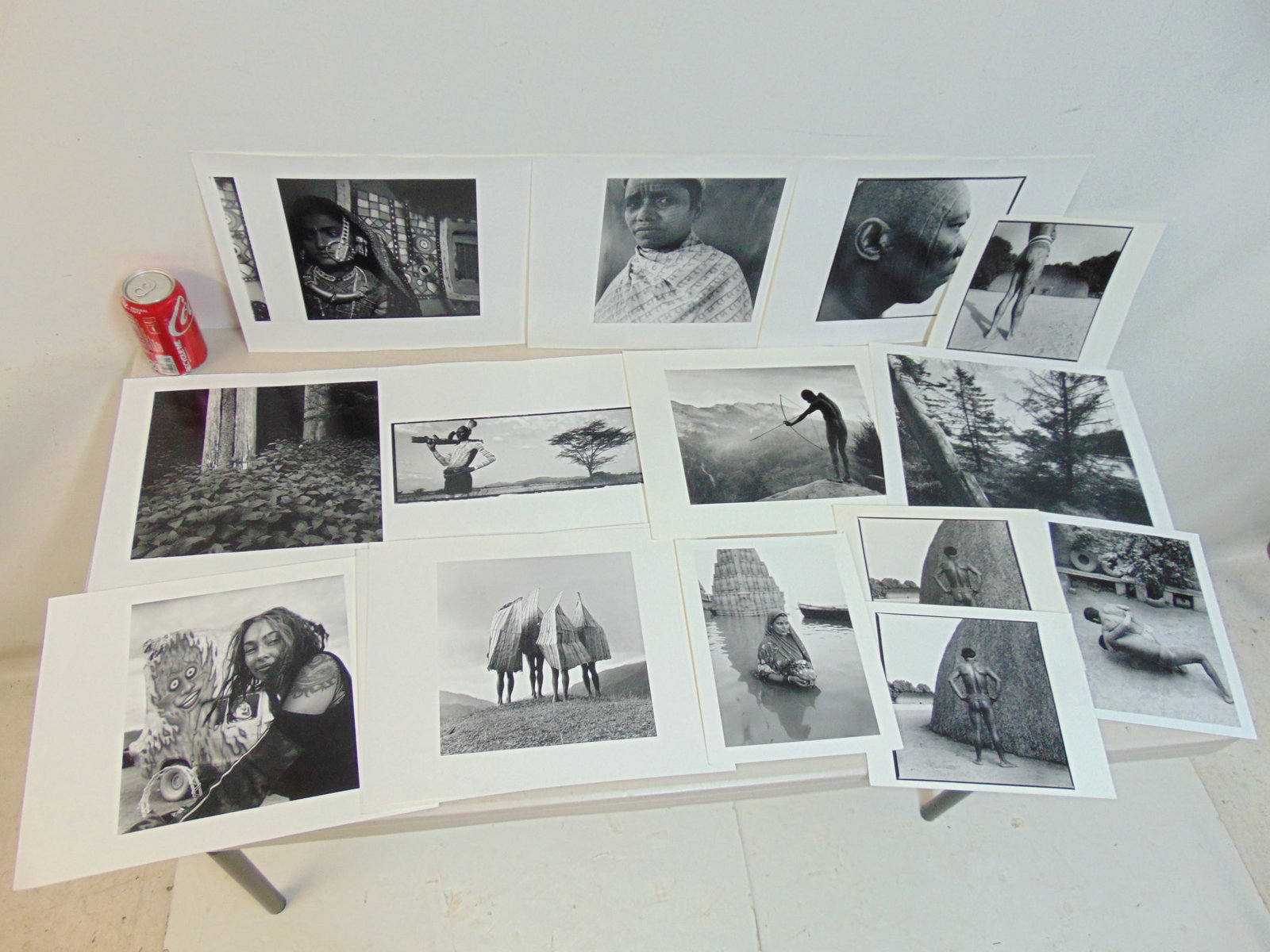 9 photographs (Iris Prints) by Chris Rainier, "Woman offering Special gifts to the river Ganges,: 9 photographs (Iris Prints) by Chris Rainier, "Woman offering Special gifts to the river Ganges, Water Temple in Background", "Xing's Tribe, Brazil Traditional Tattooing, 1997, 10 larger images are 11
