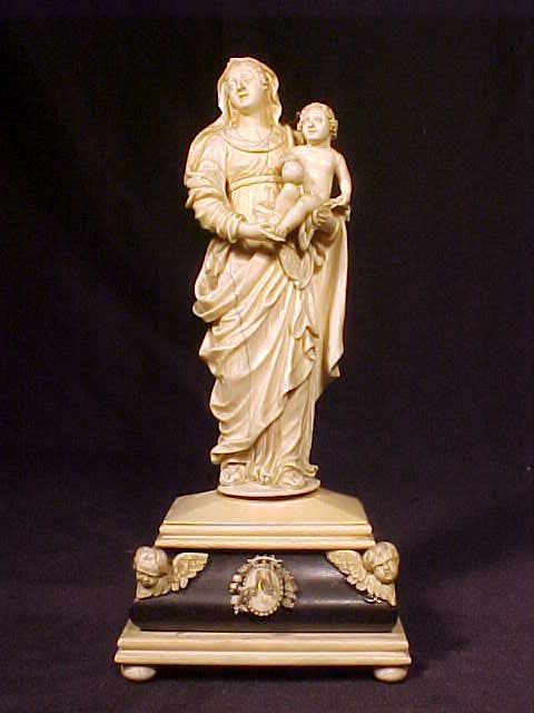 19th Century carved ivory figure Madonna & child: 19th Century carved ivory figure Madonna & child, ebony base, one corner decoration has been re-glued, Madonna has crack going lengthwise, 9.5" tall
