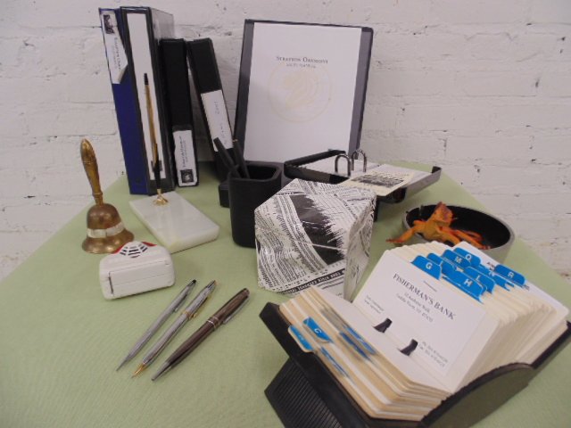 Lot desk items from the Wolf of Wall St. movie set: Large lot Stratford Oakmont folders, desk items and the "Sell me this pen" pen. Condition:good Provenance: Prop/Set Design from The Wolf of Wall Street Academy Award nominated movie
