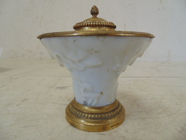 Small bronze and porcelain inkwell by Robert Linzeler: Small bronze trimmed porcelain inkwell by Robert Linzeler, 3.75" tall. Bronze lid around the pen openings worn, scratched, porcelain in good condition, sigbned on lower edge, has original glass insert