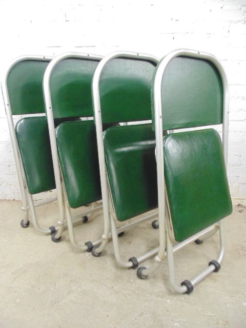 Set 4 folding chairs, Warren McArthur: Set 4 green leather & aluminum folding chairs, Warren McArthur. This lot is part of a collection of machine age chrome by makers Royalchrome, Chrometube, Warren MacArthur, Russel Wright, Wolfgang Hoff