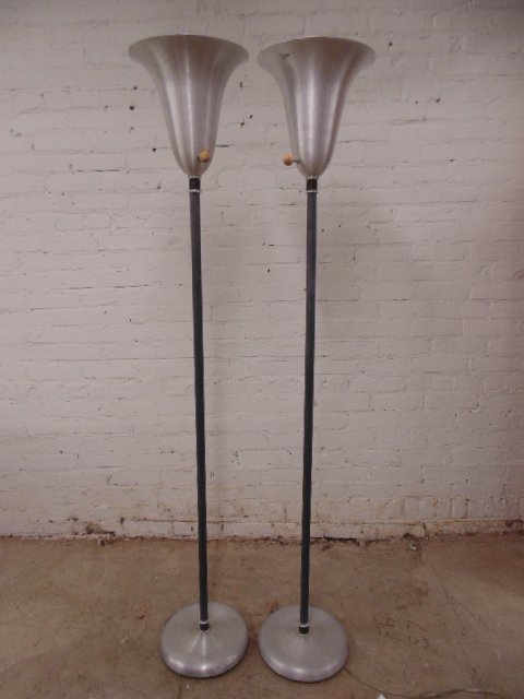 Pair Russel Wright torchier floor lamps with alu shades: Pair Russel Wright torchier floor lamps with alu shades, 64.5" tall, one lamp is loose and needs to be tightened, some scratches & minor dents on base. This lot is part of a collection of machine age