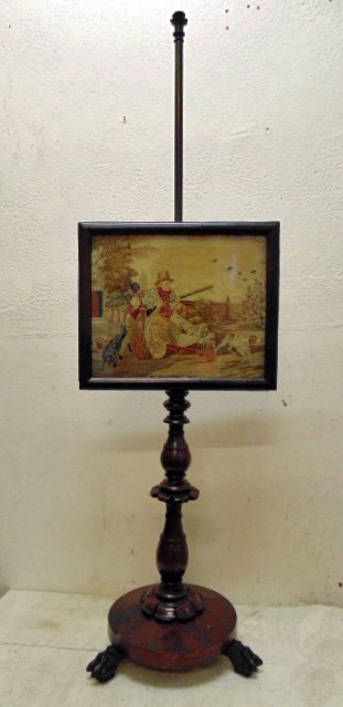 19th Century needlepoint fire pole screen: 19th Century needlepoint fire screen on pole, 61" tall one legged hunter in cart pushed by black servant scene, good original condition Note, all property herein offered for sale is strictly "as is",