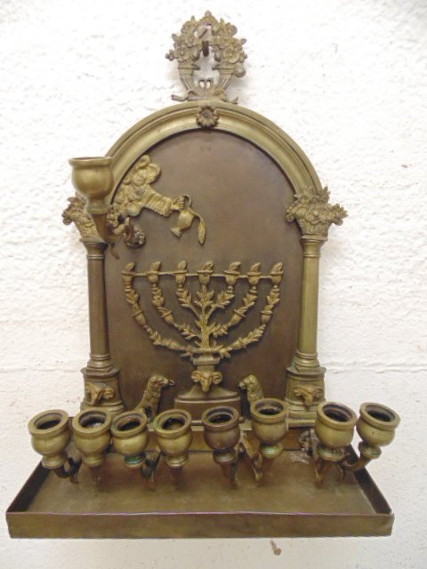 Early bronze menorah, hanging: Early brass or bronze menorah, hanging, 15.5" tall, 11.25" wide & 4.75" deep, shield back hanging with applied figures, original patina, some figures are loose. Bottom copper sheeting shows slight sep