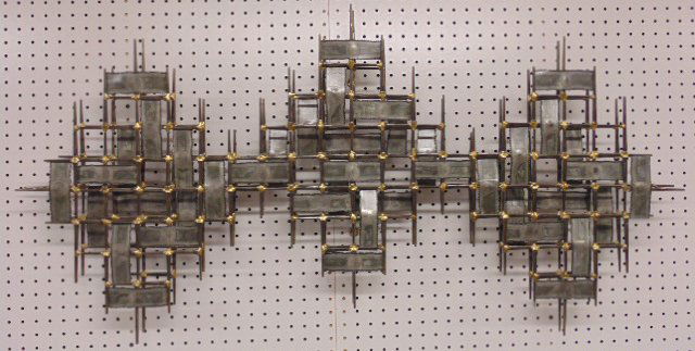 Metal wall sculpture, manner of Curtis Jere: Metal wall sculpture, manner of Curtis Jere, lacquered steel with brass welds, 48" wide, 21.5" tall, in good condition, not signed. Note, all property herein offered for sale is strictly "as is", and