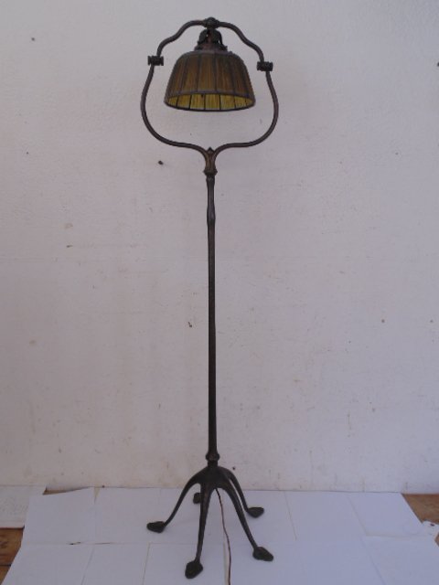 Tiffany floorlamp, split harp base with linenfold shade: Tiffany floorlamp,5 leg split harp base, original patina, has linenfold shade, some panels in shade have been replaced. 57.5" tall