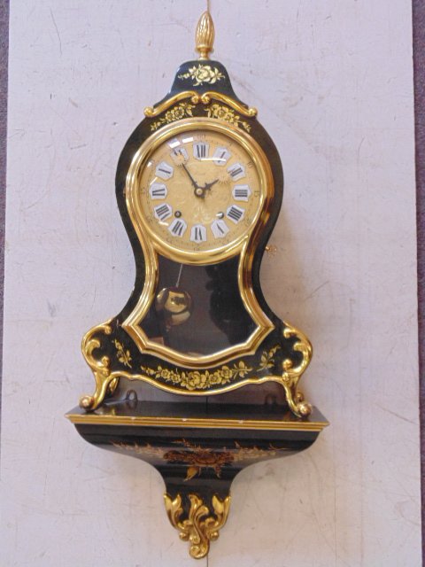 Zenith shelf clock, lacquered case: Zenith shelf clock, lacquered case, gilt decoration, with shelf, minor chips to gilt, 27" total height.