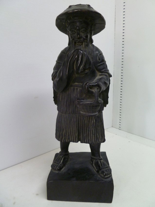 ZITAN WOOD SCULPTURE: A superb quality carving of an old Fish Seller with wide-brim hat, raincoat and carrying his basket with a fish on top. The heavy and dark wood is in excellent condition with only a single tiny split 