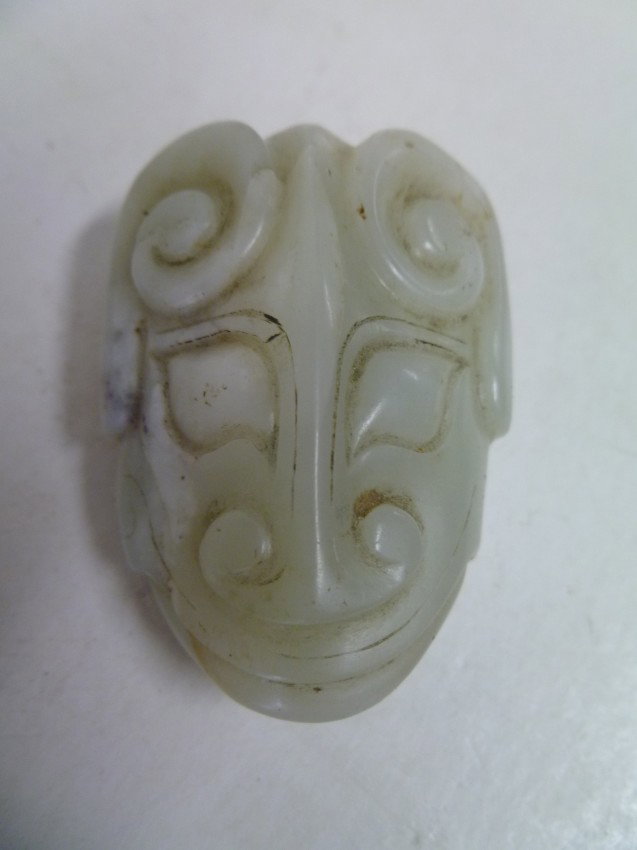 Chinese SPIRIT-FACE Jade: Likely Tribal in origin, the protective image is derived from the ancient Tao' T'ieh or "monster mask" that the Shang instituted on their bronze vessels. Bulls horns, stylized Tiger eyes, a cloud-form