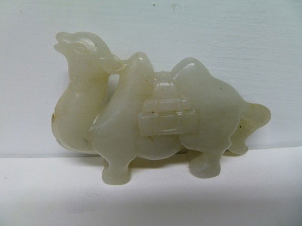 039: MING Camel Jade Carving: Silk Road use is likely in this nice and folksy hard Jade carving of a pack Camel. His head is thrown back and the bags are prominent on both sides while his tail is accentuated at the rear. In additi