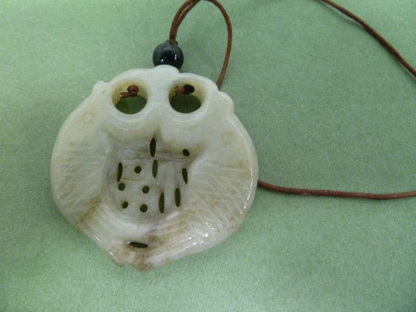 048: Double-FISH Jade Pendant: Simply carved in a Provincial 19th C. manner, they have large open mouths and a reticulated design in-between that probably is an abstracted Chinese auspicious character. 1-7/8" around.