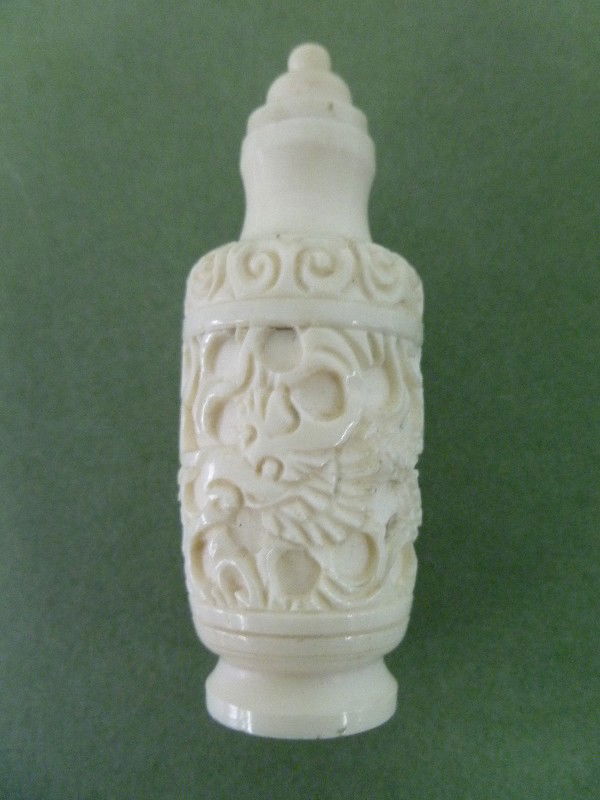 IVORY "DRAGON" Motif SNUFF Bottle: Well-carved in cylindrical form it is 2-3/4" tall including Ivory lid. The design is of a Dragon wending his way through a maze of tubular forms. Unique design for a 1930s Chinese Snuff Bottle. Does N