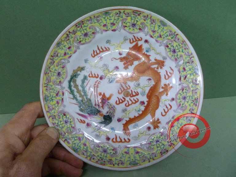 Multi-colored DRAGON & PHOENIX PLATE: Vibrantly painted in a mix of overglaze enamels, the colors fill the spaces well. Some use-wear is seen in the raised center, attesting to its truthful age. 8-3/4" across, the yellow enameling covers 