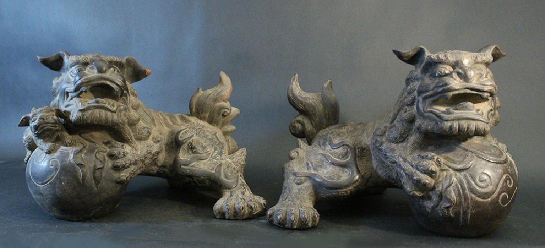 Pair of Chinese ceramic lions; open mouths; on two big: Pair of Chinese ceramic lions; open mouths; on two big pearls; the female with its baby; Qing Dynasty; a pair.