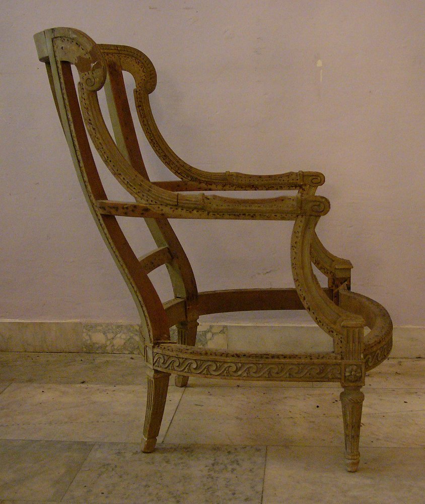 French Bergere (without tapestry) in Louis XVI manner, : French Bergere (without tapestry) in Louis XVI manner, on four legs, two armrests and back rest with ears, all parts carved with classical decorations. Old white paint partly visible. Needs restoratio