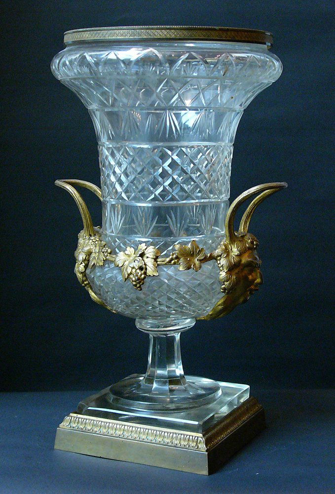Russian glass vase, with cutted decorations on slim foo: Russian glass vase, with cutted decorations on slim foot ending in geometrical base. Mounted on base, vase and border with gilted bronce mounts and Saturn heads hand grips, Russian 19th Century. Ruptu