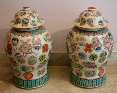 Pair of Chinese Vases round circular form with two lids: Pair of Chinese Vases round circular form with two lids crowned wth nops, multi coloured painted with floral decorations. Signs of age, well. height 45cm Asian