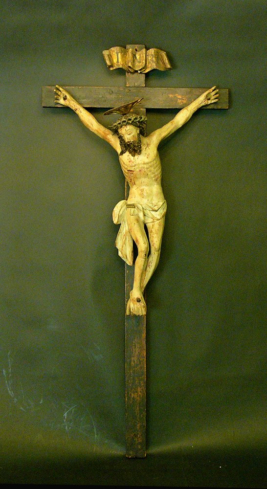 Bavarian or Tyrolean Crucifix, with slightly bent feet: Bavarian or Tyrolean Crucifix, with slightly bent feet and folded loincloth, wood naturalistically carved with the Crown of Sorrows and a gilded halo. Naturalistically painted, on old black wooden cro