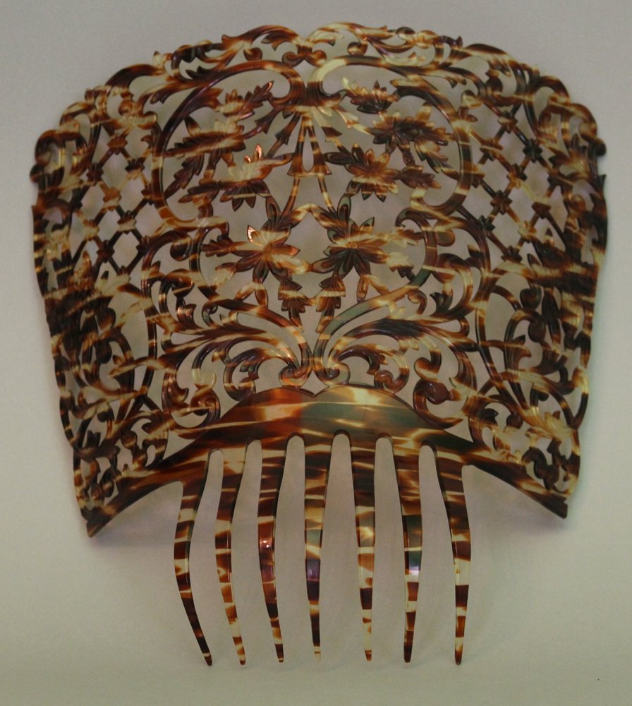Tortoise shell imitation large hair comb: Tortoise shell imitation large hair comb decoration in Belle poque manner with open work decorations , height 26 cm width 28 cm