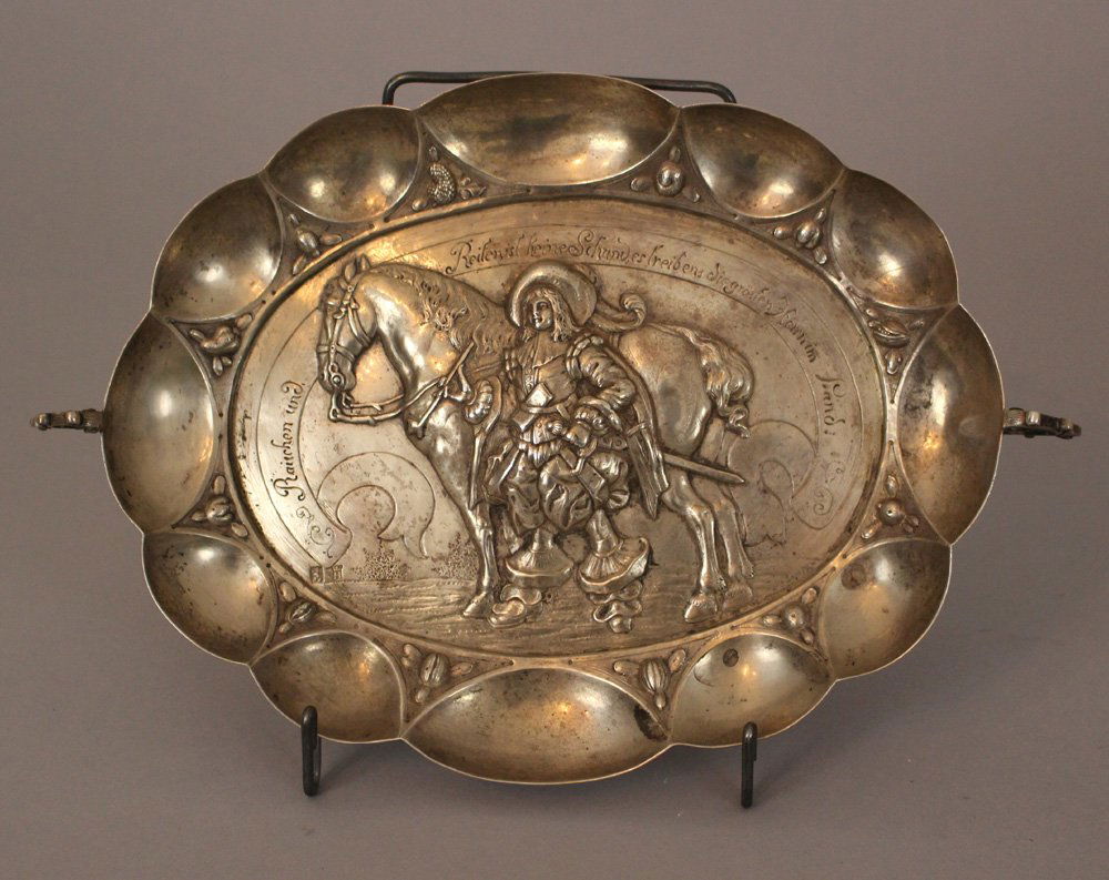 Small silver bowl, oval form with two hand grips and bo: Small silver bowl, oval form with two hand grips and bowed border, in the centre a noble man with his horse and drescription in German "Rauchen und Reiten ist keine Schand, es treibens die grösten He
