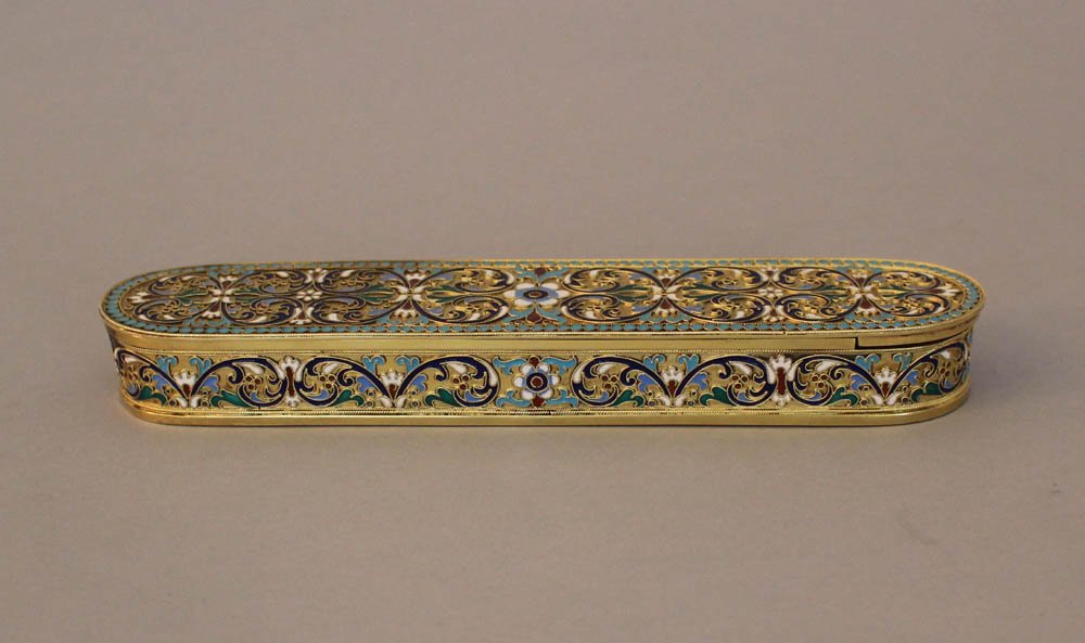 Russian silver box, oval shape with one lid, partly gil: Russian silver box, oval shape with one lid, partly gilded and decorated with floral enamel ornaments, several Russian hall marks on the underside, inside four sections; weight 470g length 21cm, width