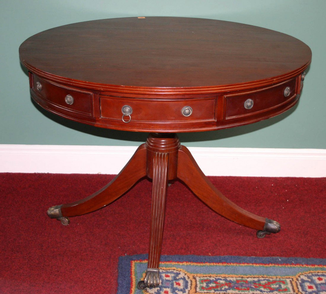 A circular mahogany Library Drum Table, George III : A circular mahogany Library Drum Table, George III style - modern, with four frieze and four mock drawers, on a quadruple pod, 42" (107cms). (1)