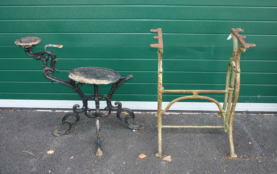 A cast iron Garden Bench, with wooden rails and se: A cast iron Garden Bench, with wooden rails and seat, as is, together with a pair of cast iron set ends and a Victorian cast iron Plant Stand, as is, and a cast iron Sewing Machine Base. (5)