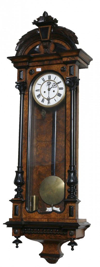 A fine quality ebonised and figured walnut Vienna: A fine quality ebonised and figured walnut Vienna Regulator Wall Clock, 19th century, the arched top with a leaf crest and an inverted breakfront cornice, above a glass door enclosing a two stage enam