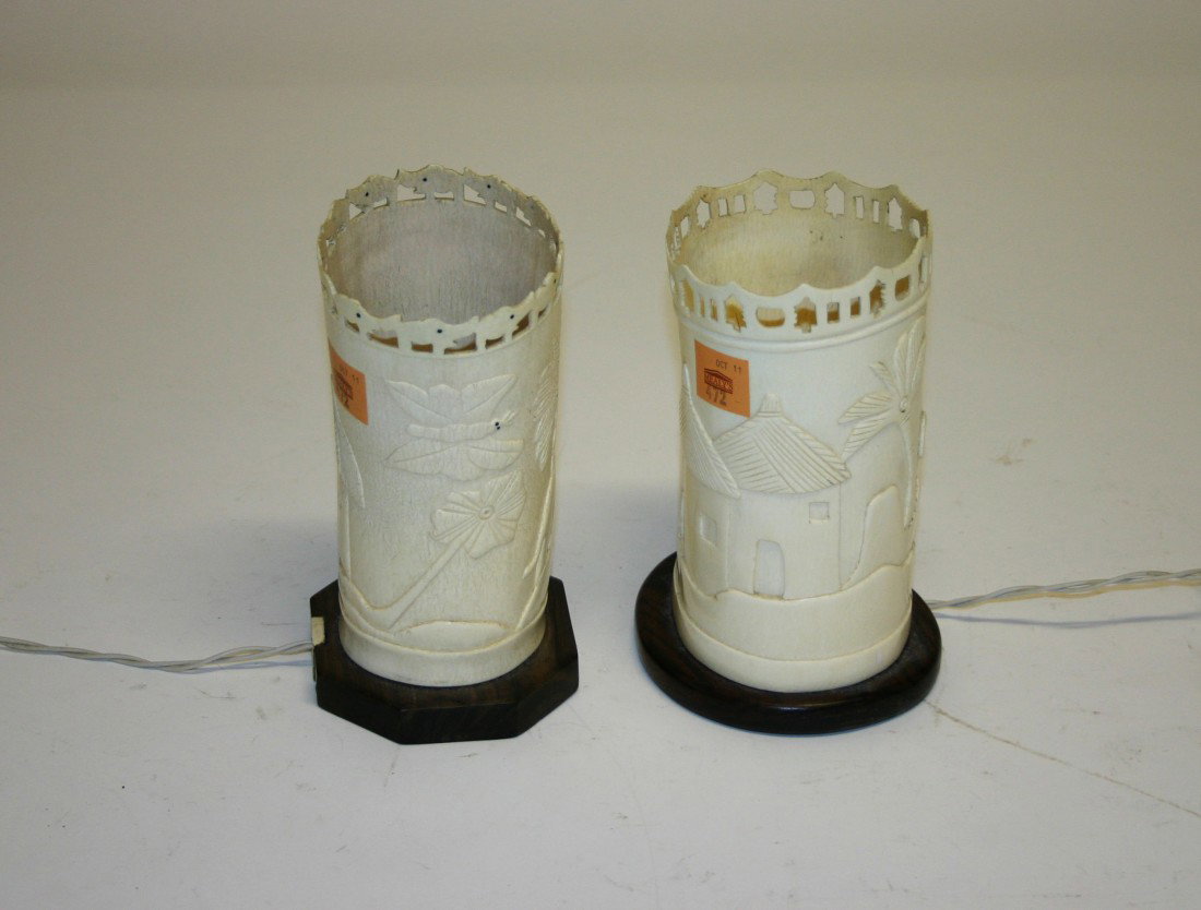 A pair of African ivory Tusk Vases or Lamps, each : A pair of African ivory Tusk Vases or Lamps, each on a salamander base with a pierced rim, electrified, 8" (21cms). (2)