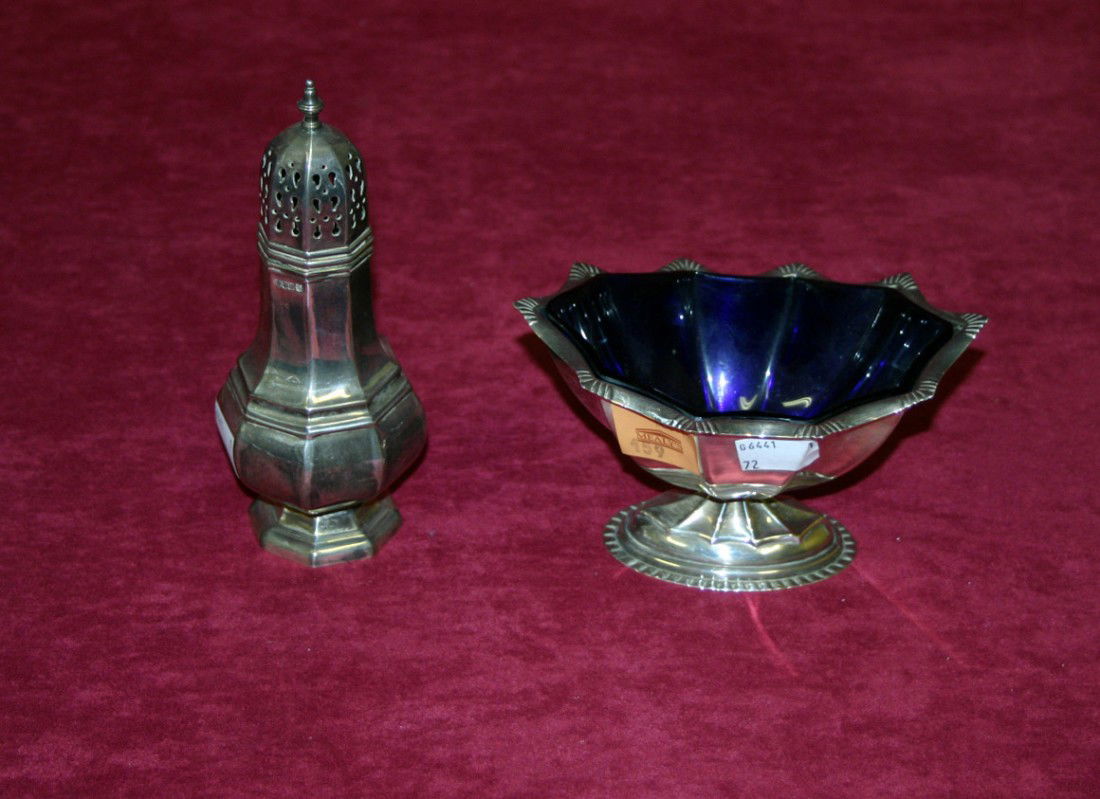 An Irish boat shaped silver Sugar Bowl, commemorat: An Irish boat shaped silver Sugar Bowl, commemorating 1973, "Ireland's Entry into the European Community", on stemmed base, 6" (15cms), together with an octagonal baluster shaped Sugar Castor, 1973. (