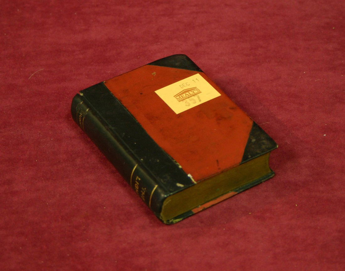 A book-form novelty Dunhill cigarette lighter, wit: A book-form novelty Dunhill cigarette lighter, with lacquered cover, the spine inscribed The LIght 4.5" (11cms)