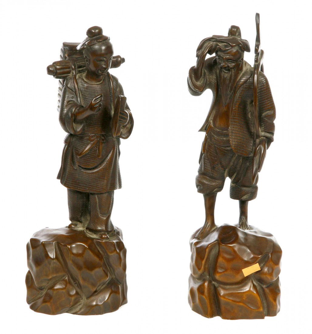 A pair of carved Chinese wooden figures, one depic: A pair of carved Chinese wooden figures, one depicting a woman carrying a basket on her back, the other a man with a saw, 12.5" (32cms). (2).