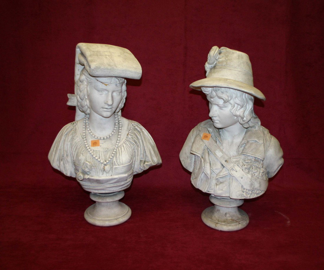 A. Carini, A pair of Italian chalk busts, one mode: A. Carini, A pair of Italian chalk busts, one modelled as a woman wearing pearl necklace and her hair in plaits, the other a young man with shoulder belt and hat 27" (69cms) approx