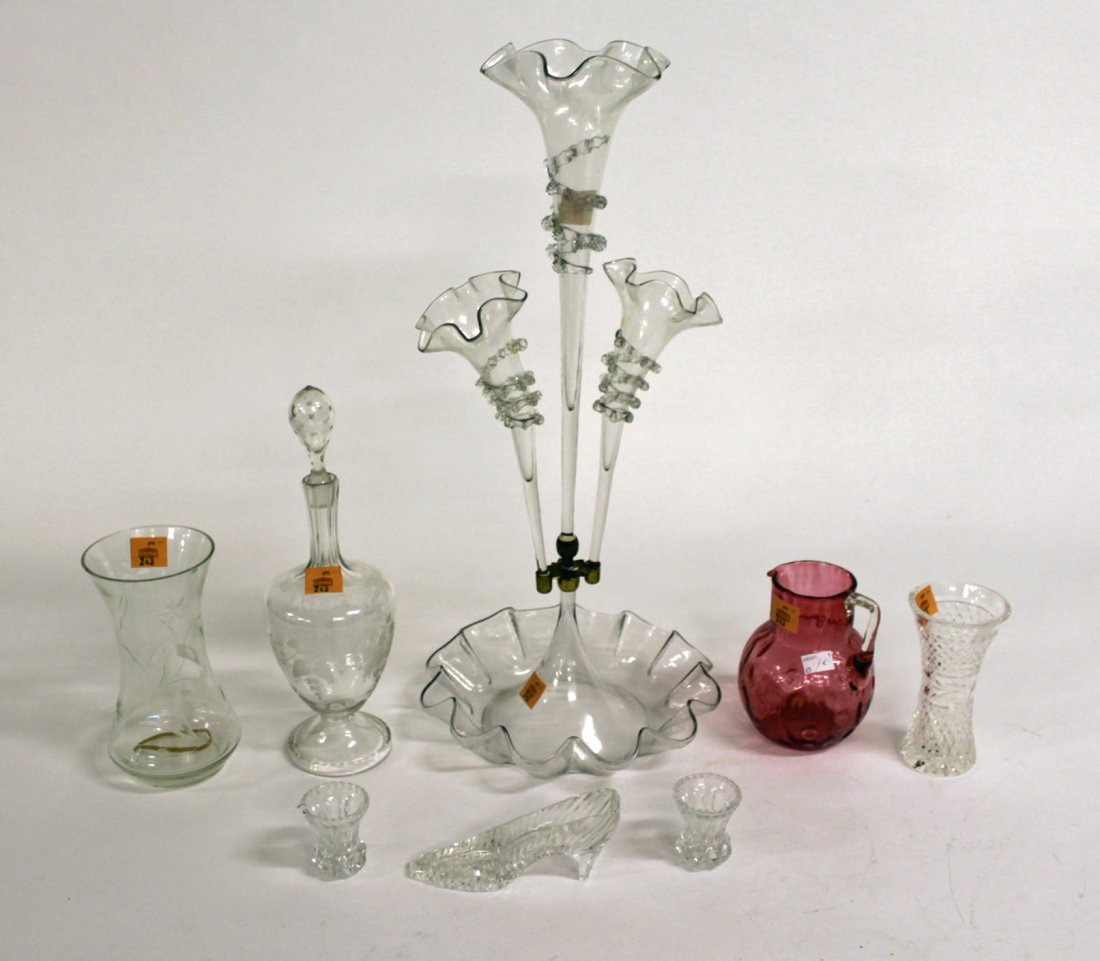 A glass Epergne, Victorian, with three cone shaped: A glass Epergne, Victorian, with three cone shaped vases, on a glass bowl, 24" (61cms), together with an etched glass Decanter and stopper on stemmed foot, a cranberry glass Water Jug, a pair of small
