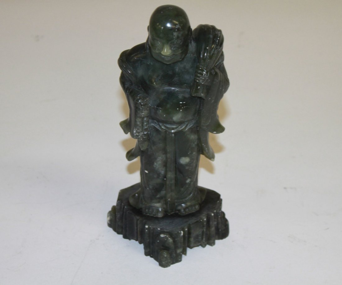 A Chinese spinach coloured soap-stone figure of a : A Chinese spinach coloured soap-stone figure of a Buddha, 9.5" (24cms). (1).