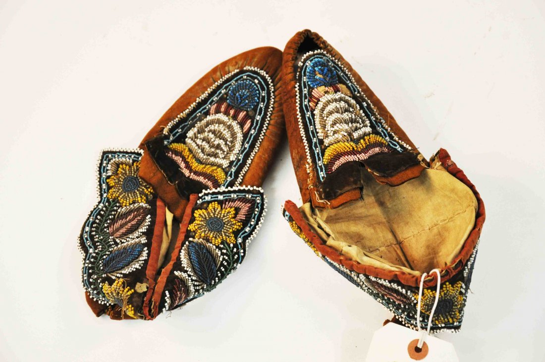 A pair of early bead tapestry Native American Mocc: A pair of early bead tapestry Native American Moccasins, the bead tapestry in floral designs. (2).