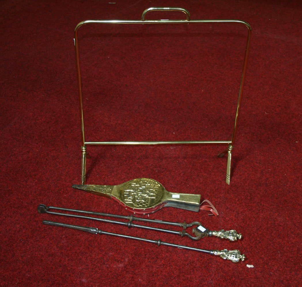 A cheval firescreen, Edwardian, lacking panel; a p: A cheval firescreen, Edwardian, lacking panel; a pair of brass mounted steel fire irons and a brass bellows. (4).