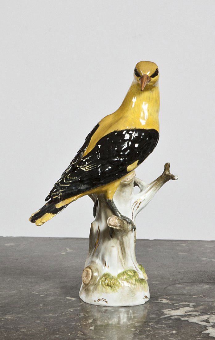 A Meissen model of a golden Oriole,: A Meissen model of a golden Oriole, circa 1860, blue crossed swords mark, incised 820x and Pressnummer 92, naturalistically modelled perched on a tree-stump (some damage and restoration to its beak an