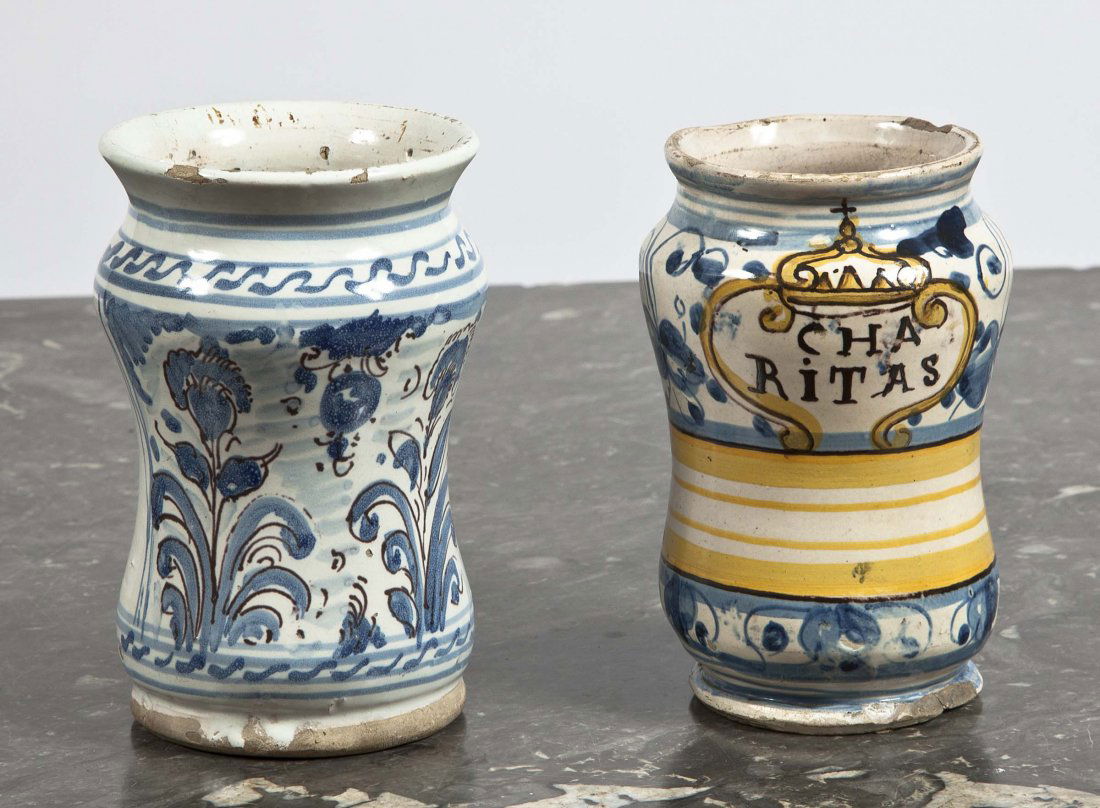 Two Italian Maiolica Albarelli: Two Italian Maiolica Albarelli both 17th Century, the first probably Montelupo, named for CHA/RITAS within a crowned cartouche above a plain label reserved on a ground of blue and white fruit and leav