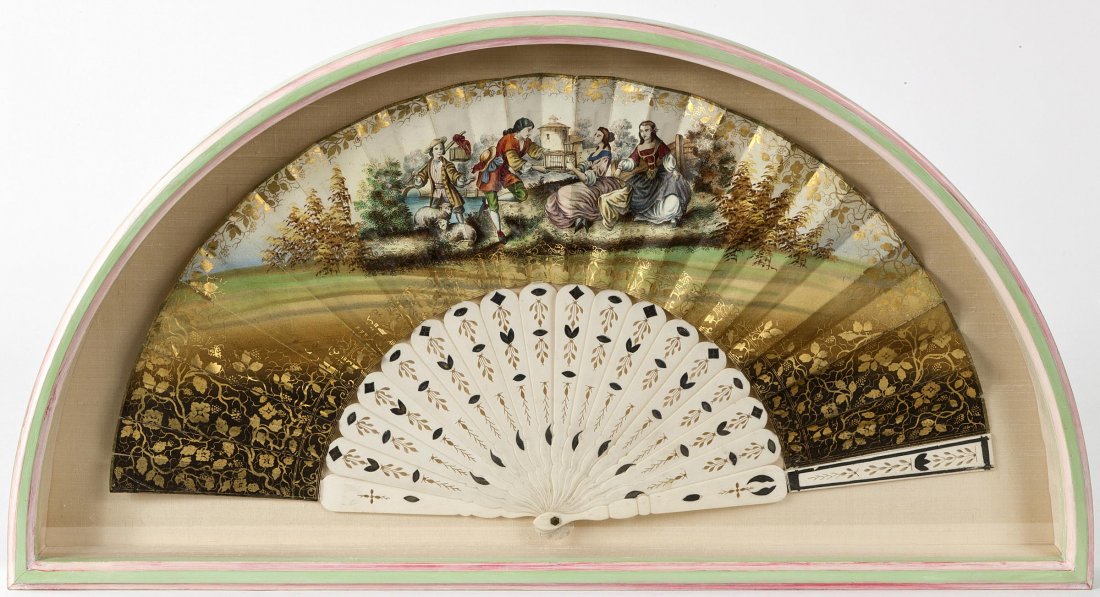 CONTINENTAL SCHOOL, EARLY 19TH CENTURY : CONTINENTAL SCHOOL, EARLY 19TH CENTURY A painted fan with pedlar's selling wares to two girls by a roadside, gouache with gold decoration on ivory sticks, 18" x 10 ½" (46cms x 27cms). (1)