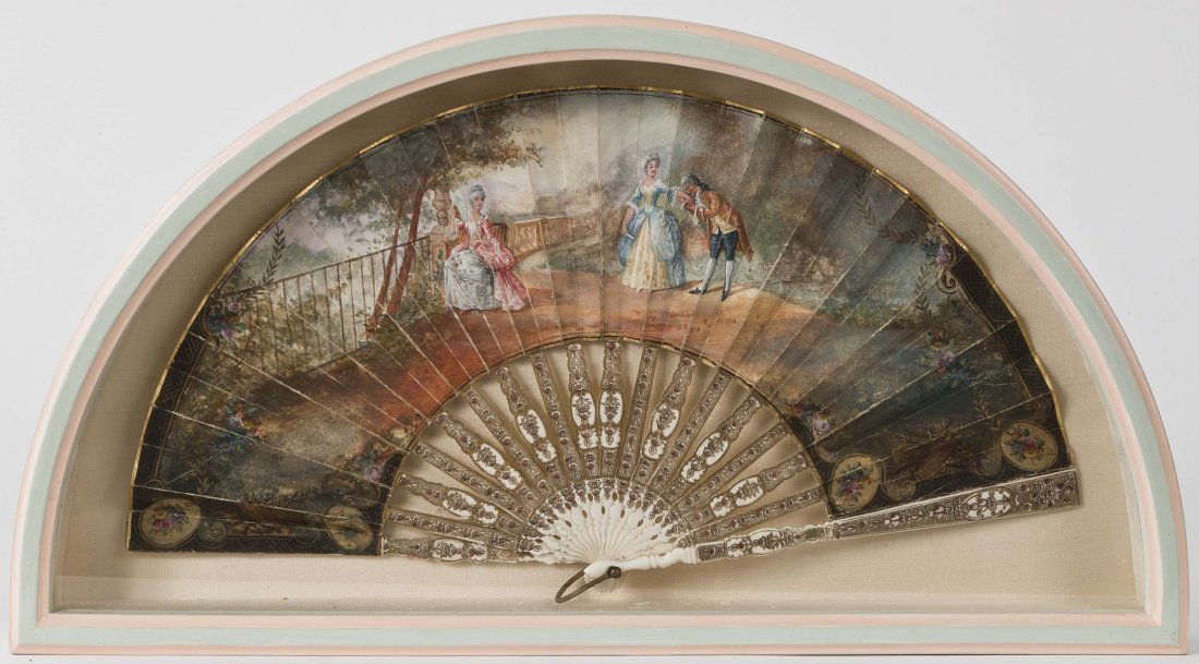 19TH CENTURY CONTINENTAL SCHOOL: 19TH CENTURY CONTINENTAL SCHOOLA painted fan depicting elegant figures on a terrace, landscape beyond, gouache on gold engraved ivory sticks, 9" x 15 ½” (22cms x 40cms). (1).