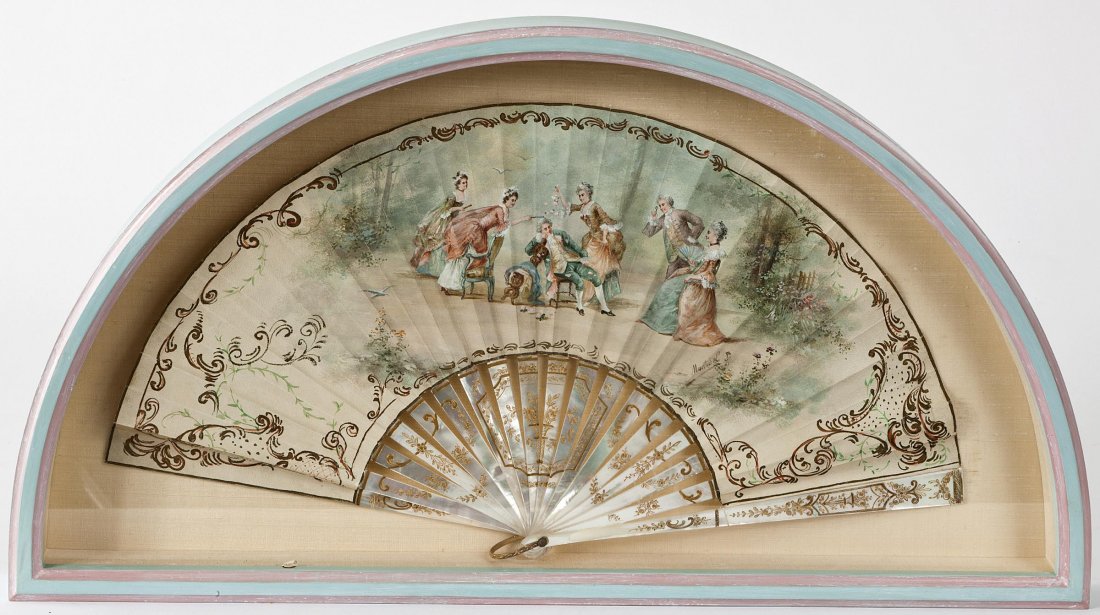 LATE 19TH CENTURY CONTINENTAL SCHOOL: LATE 19TH CENTURY CONTINENTAL SCHOOL A painted fan with elegant figures teasing a sleeping man, gouache on mother-of-pearl sticks engraved with gold, 9" x 18" (23cms x 46cms). (1).