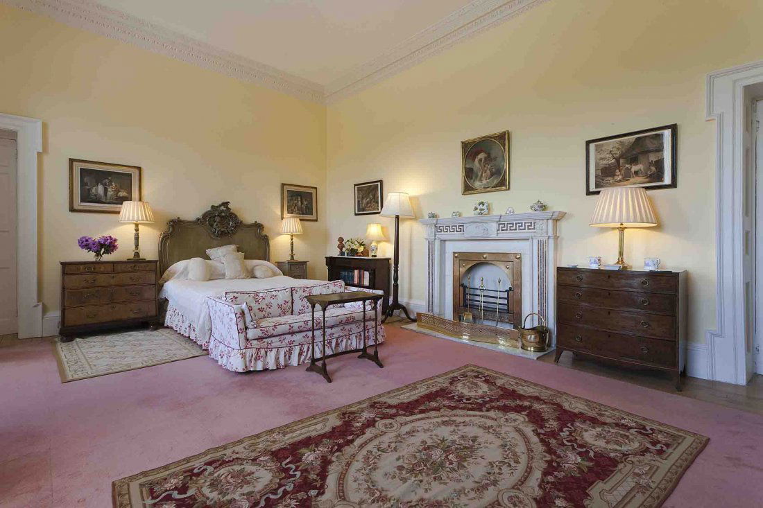 An Italian green-painted and silvered double Headb: An Italian green-painted and silvered double Headboard, 19th Century,of moulded serpentine form, the angles carved with C-scrolls, flower heads and scrolling acanthus foliage, the cresting carved with